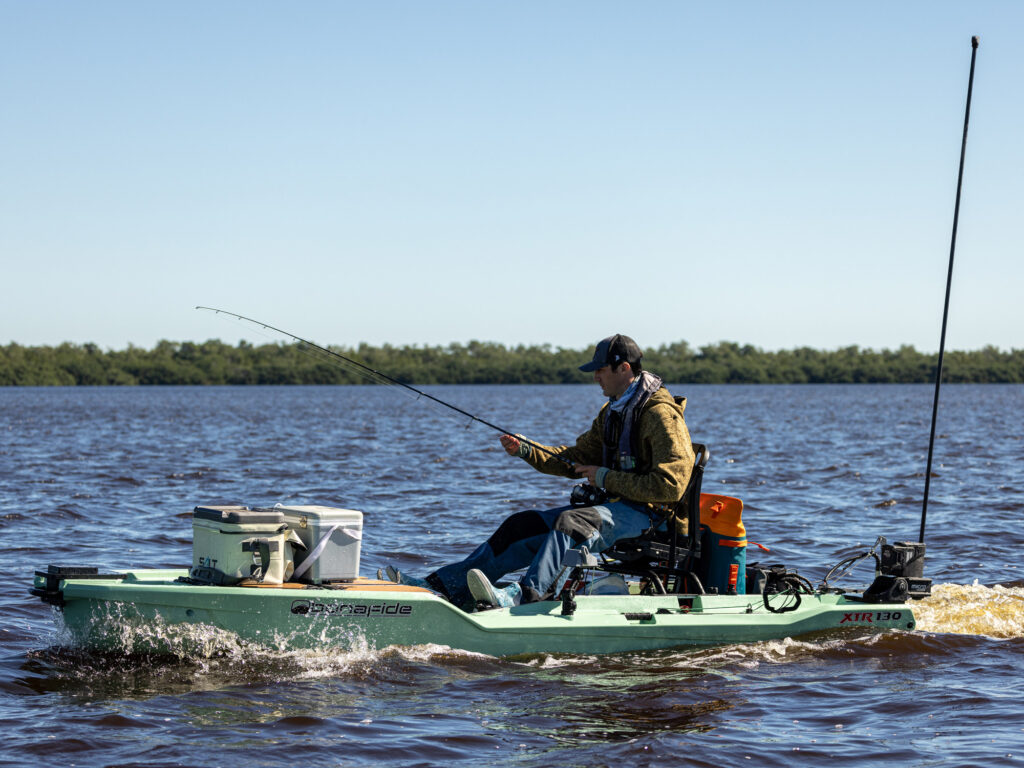 Motorized Bonafide kayak with running across open water.