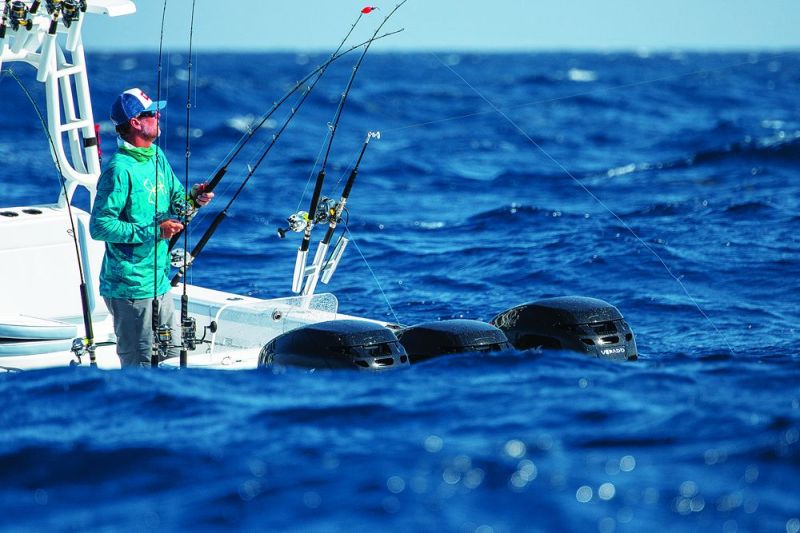 An angler feeds line to a fish in vey rough conditions
