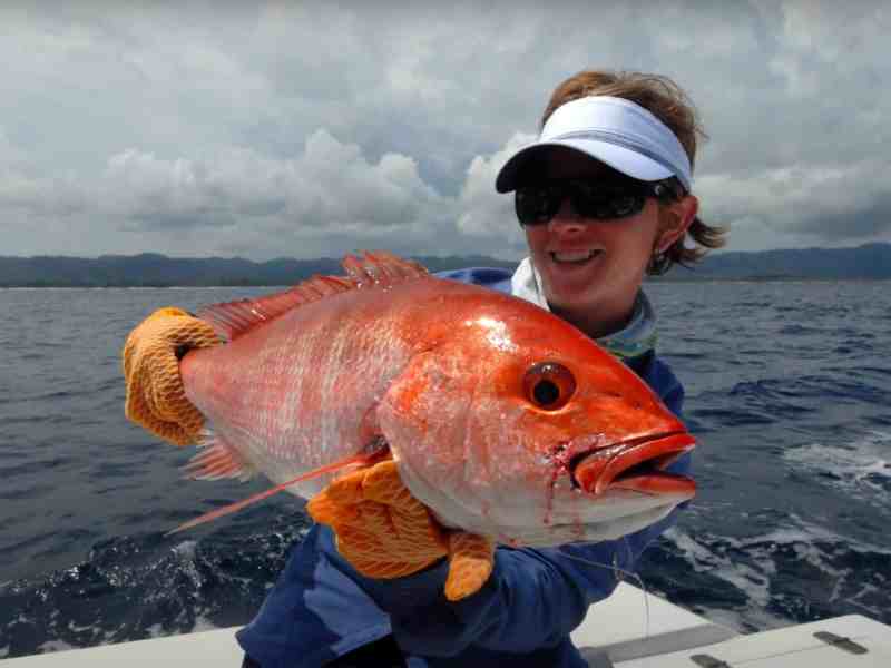 Women angler holding up a fish